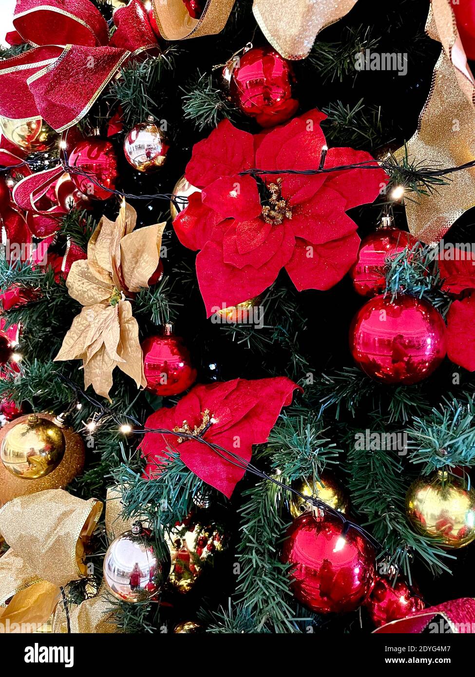 Interior well decorated Christmas tree. Magic glowing tree, fireplace