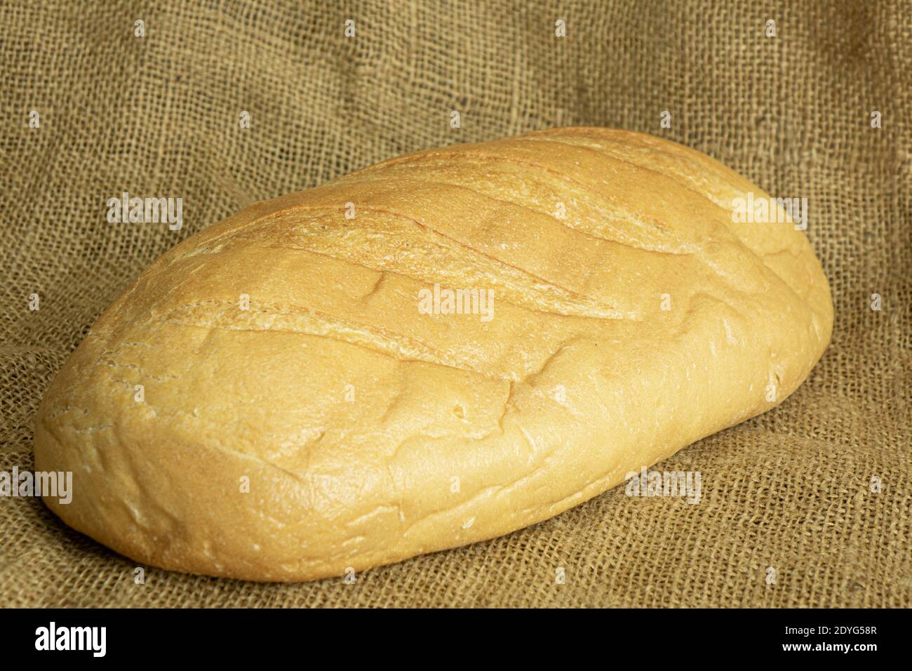 Fresh handmade bread on sackcloth background Stock Photo