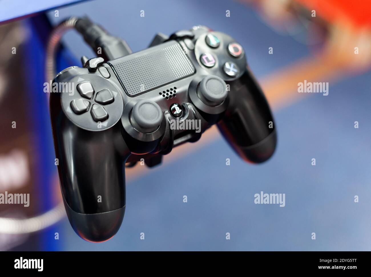 PS4 controller closeup, shallow depth of field. PlayStation 4 pad plugged in up close. Console gamepad, input devices concept, technology, nobody Stock Photo