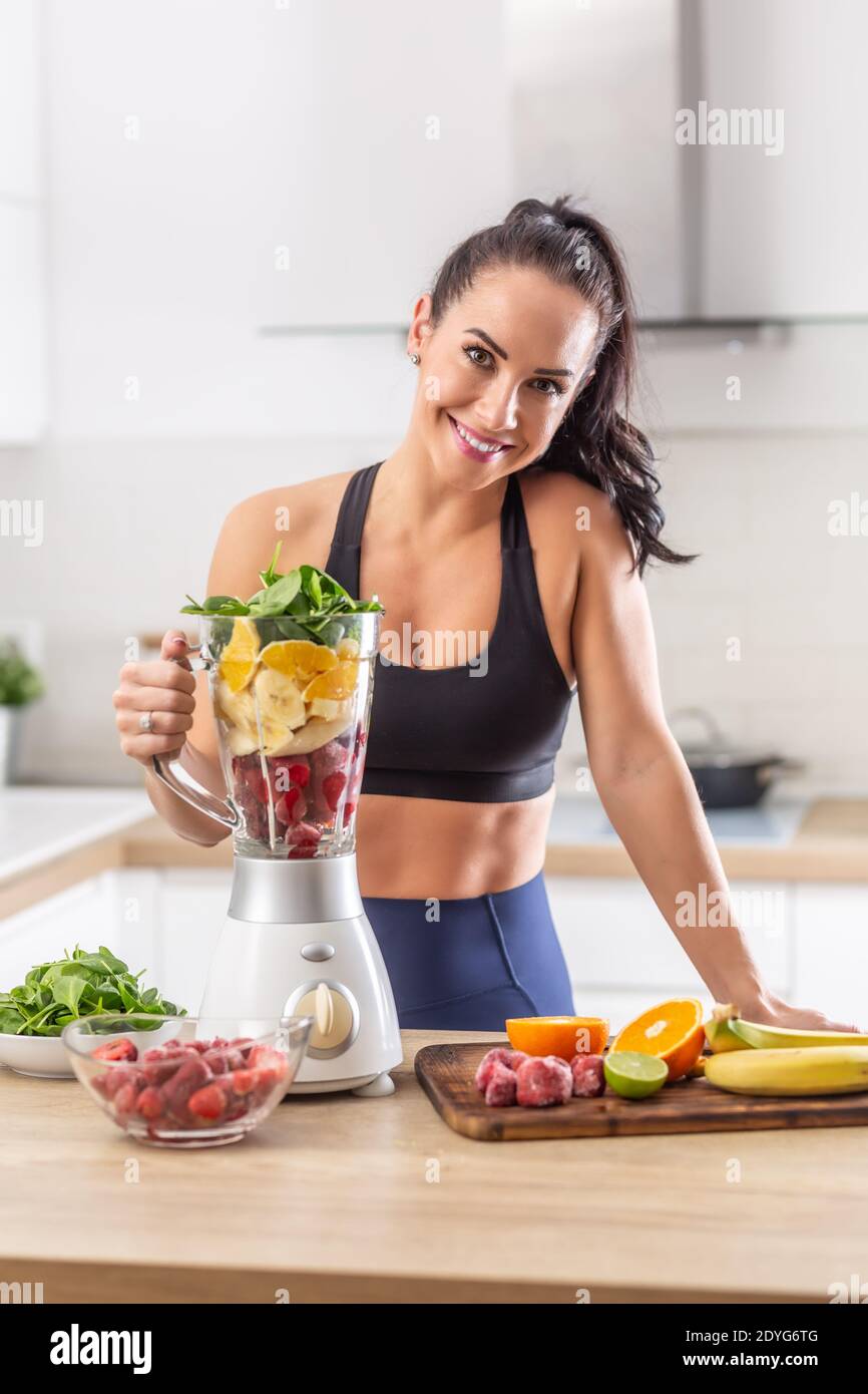 Postworkout nutrition for a woman in fitness clothes in a form of red