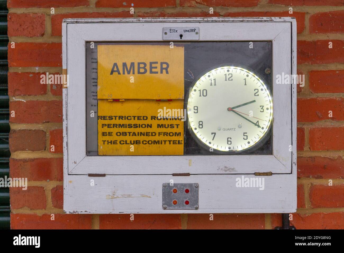 Warning sign for rowers from the Maidenhead Rowing Club set to AMBER on the River Thames, UK, indicating permission required to row on the river. Stock Photo