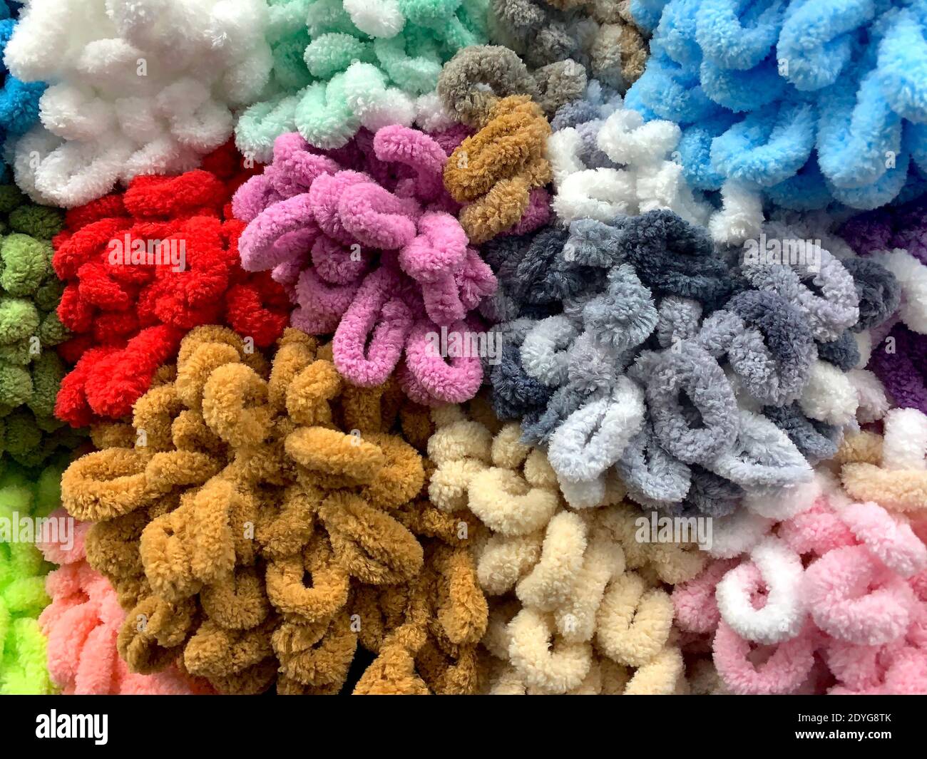 Multicolored skeins of plush yarn for hand knitting with ready made