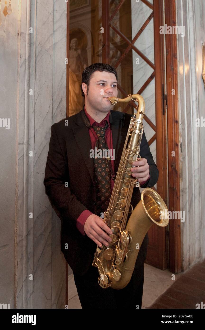 Saxophonist playing saxophone in luxury villa Stock Photo