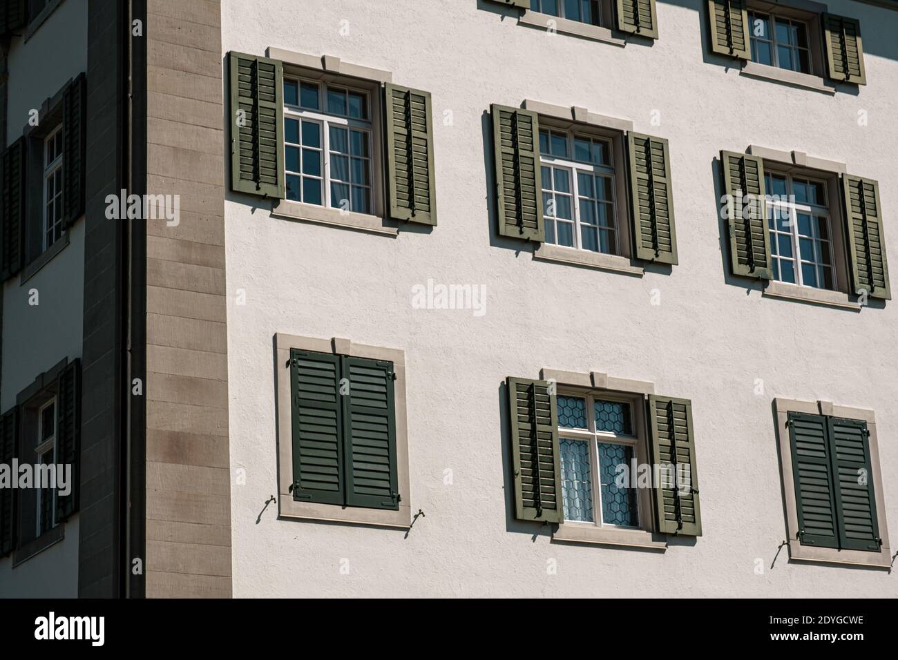 rustic windows with green shutters Switzerland. Stock Photo