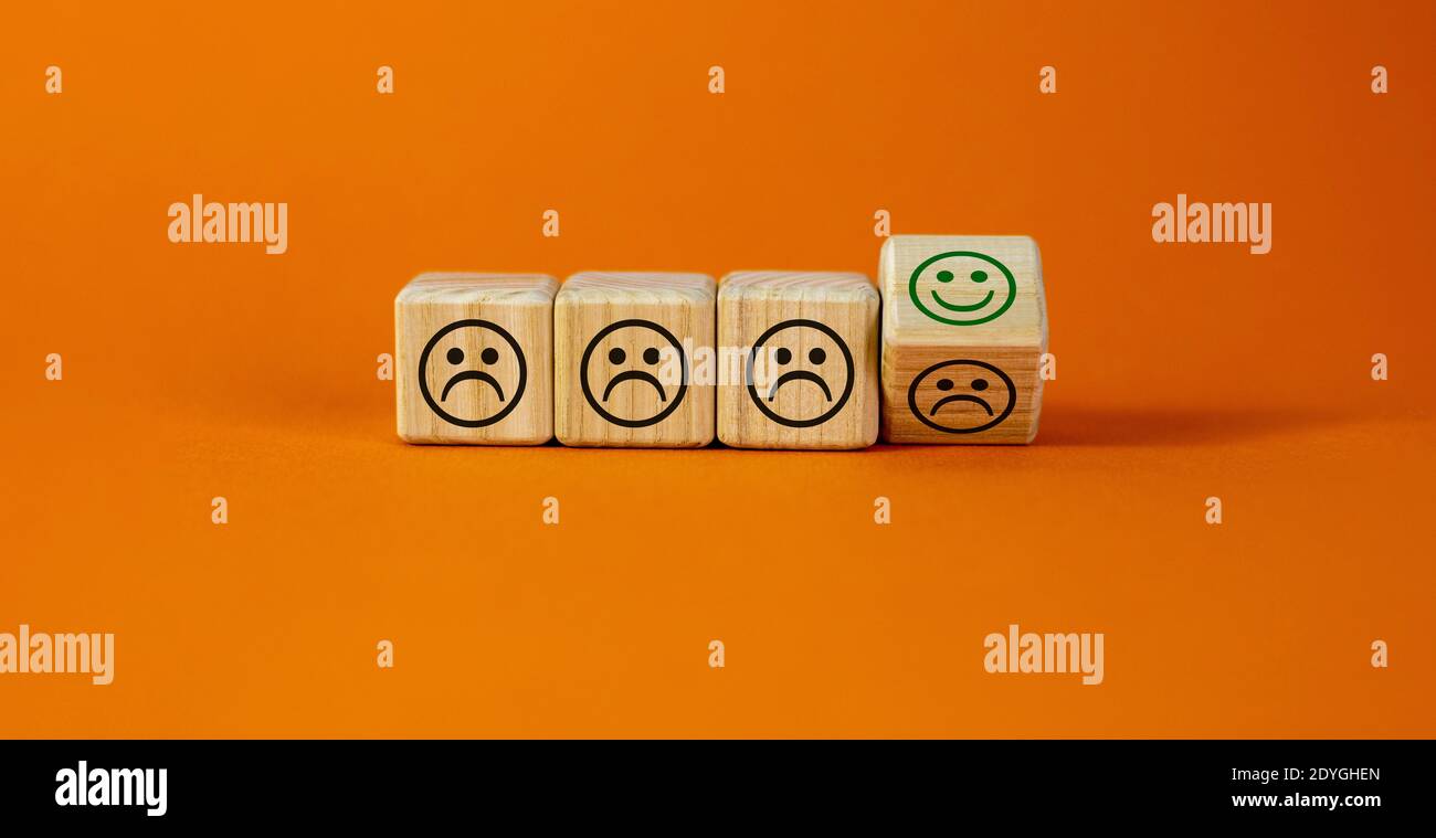 Various emoticons symbol. Turned a cube and changed negative smile to positive. Business and various emoticons concept. Beautiful white background, co Stock Photo