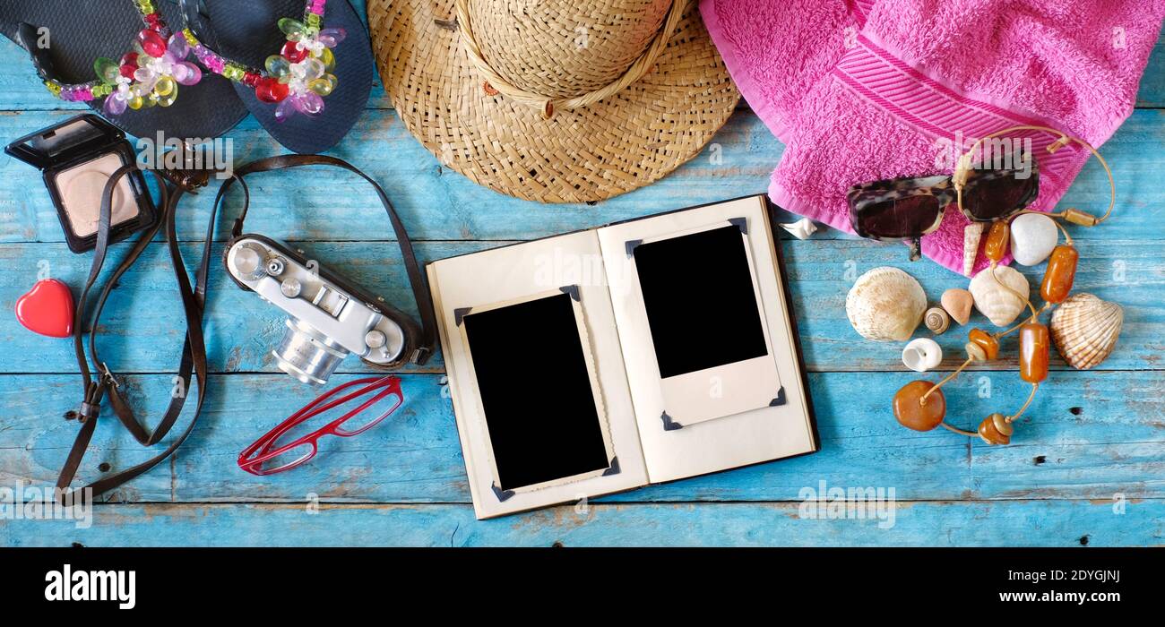 enjoying photography during summer holidays, camera, photo album with empty frames and vacation items,flat lay Stock Photo