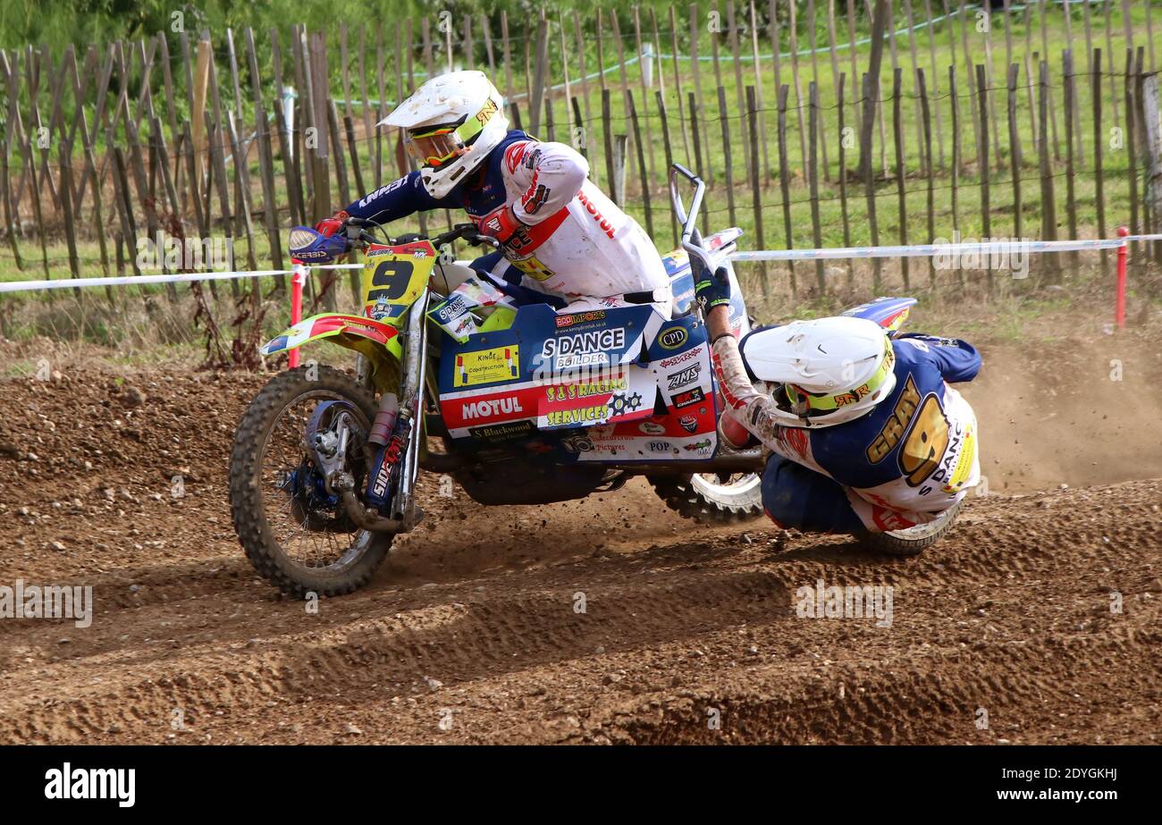 sidecar outfits flying round a bens on a motocross track as they take a bend Stock Photo