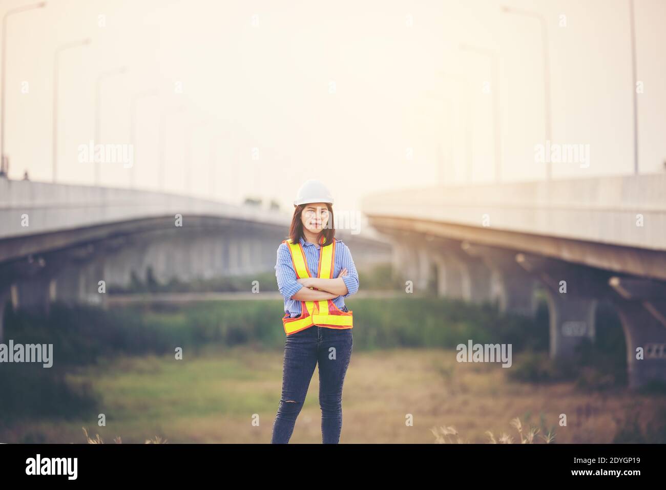 Female engineer with helmet showing thumb up as ok sign at construction site. Power of women, Gender equality, Working women, Confident Female Enginee Stock Photo