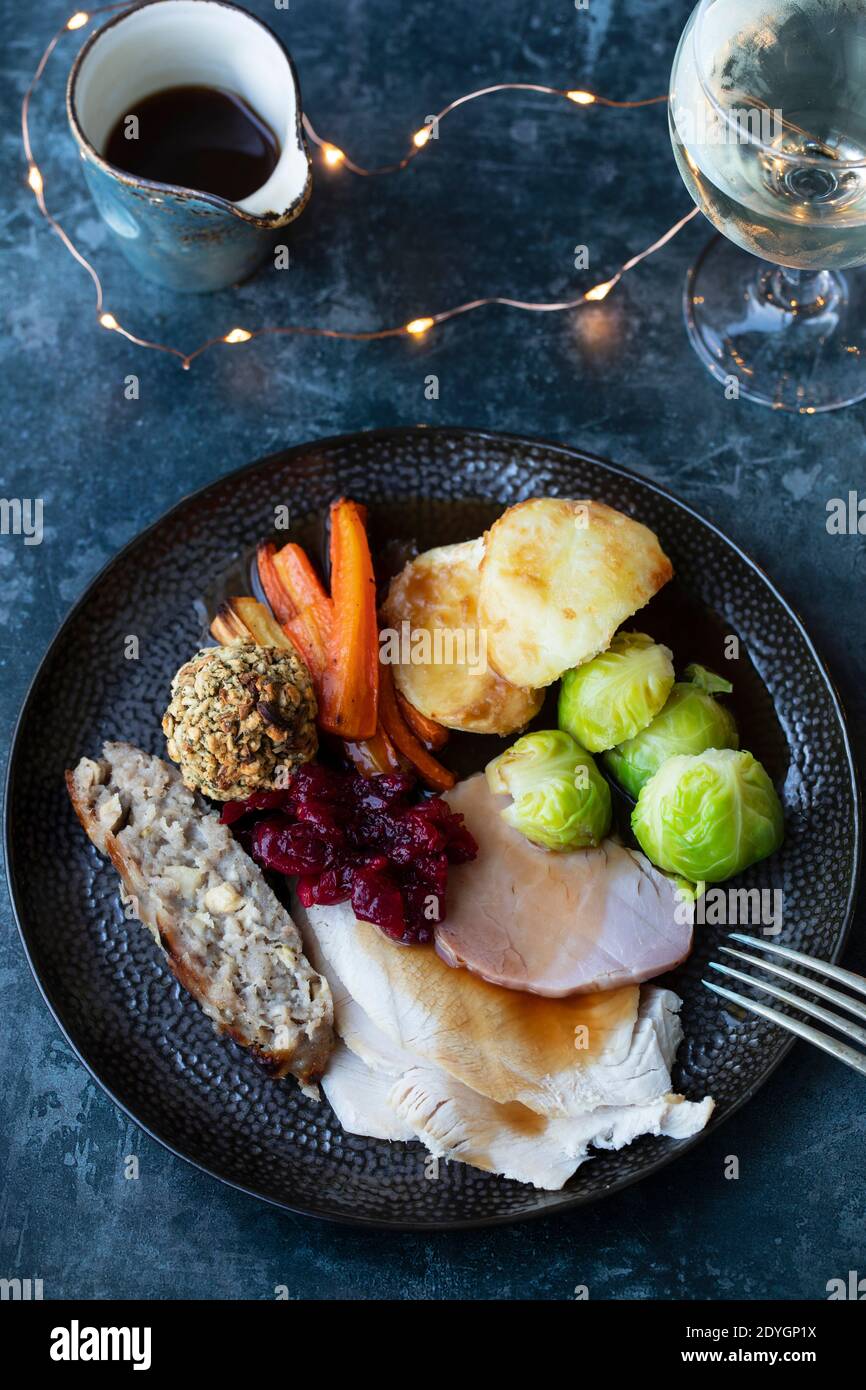 Christmas dinner witt turkey, sausage meat, roast potatoes, stuffing and cranbery sauce Stock Photo
