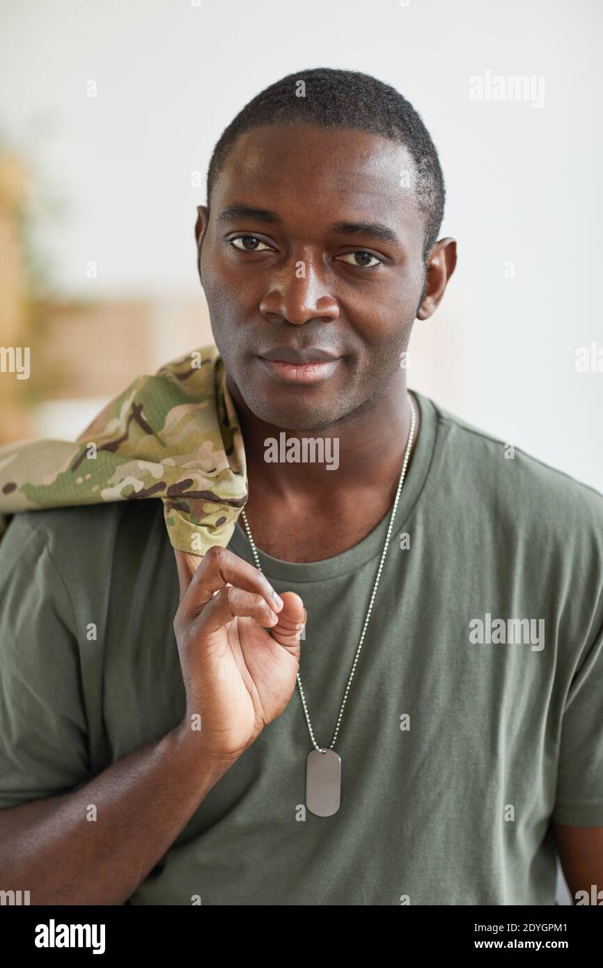 Portrait of African young military man with badge smiling at camera Stock Photo