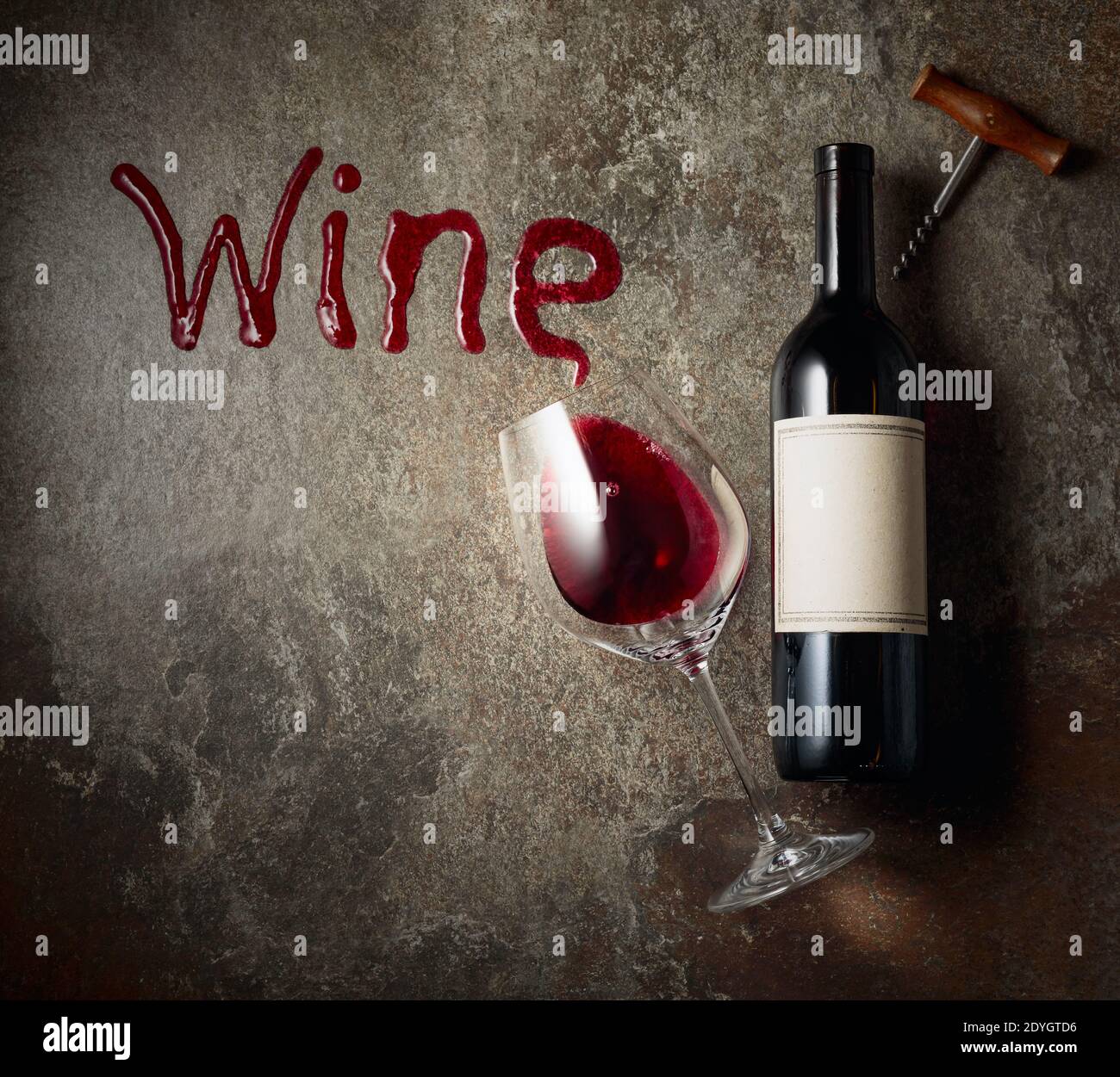 Red wine on an old rough background. Bottle with an old empty label