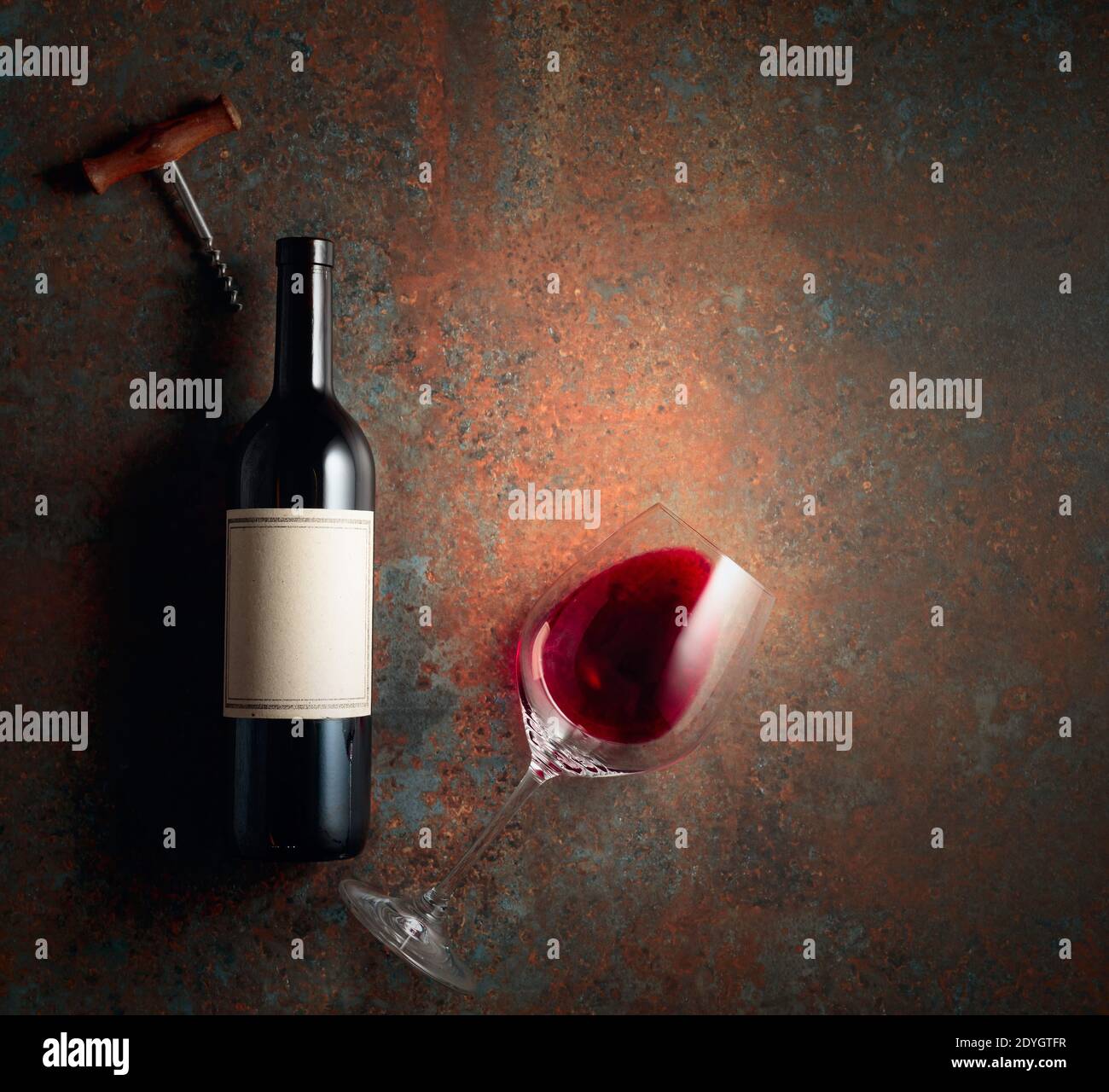 Red wine on an old rough background. Bottle with an old empty label