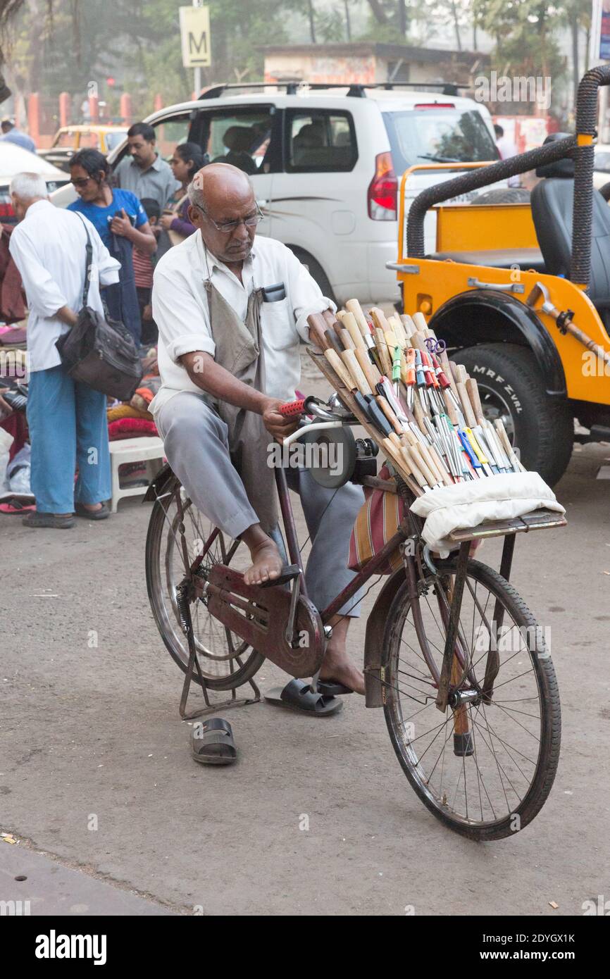 Mumbai India Knife Vendor sharpening knives with his bicycle Stock Photo