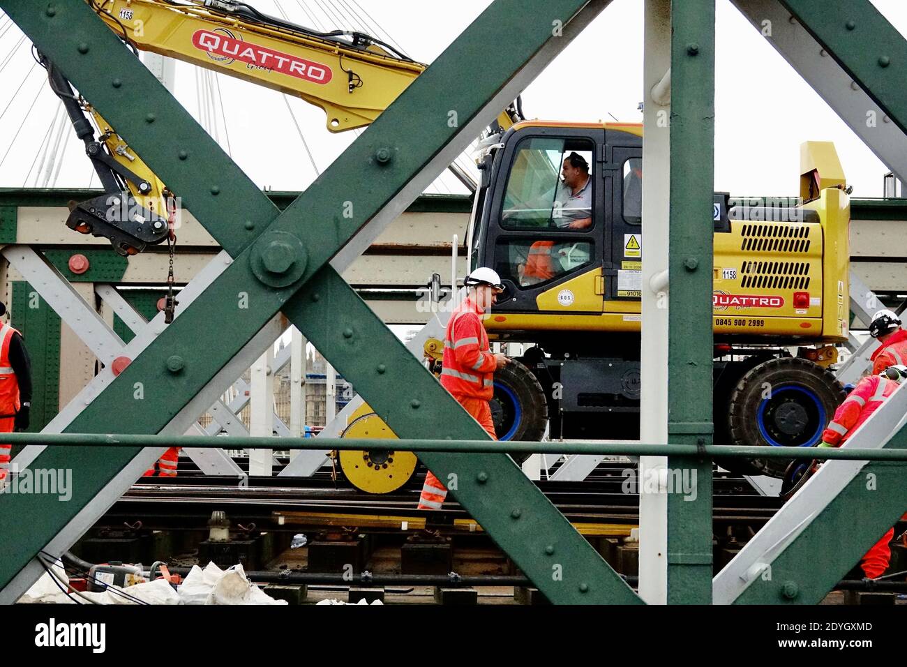 Man operates Quattro rail crane on the Hungerford rail bridge at Charing Cross on Boxing Day during Network Rail maintenance. Stock Photo