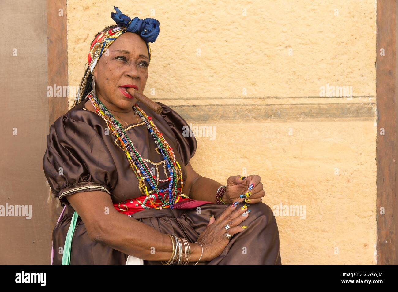 Lady In Traditional Dress Smoking A Cigar In Old Havana Stock Photo