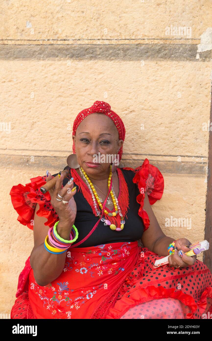 Lady In Traditional Dress Smoking A Cigar In Old Havana Stock Photo