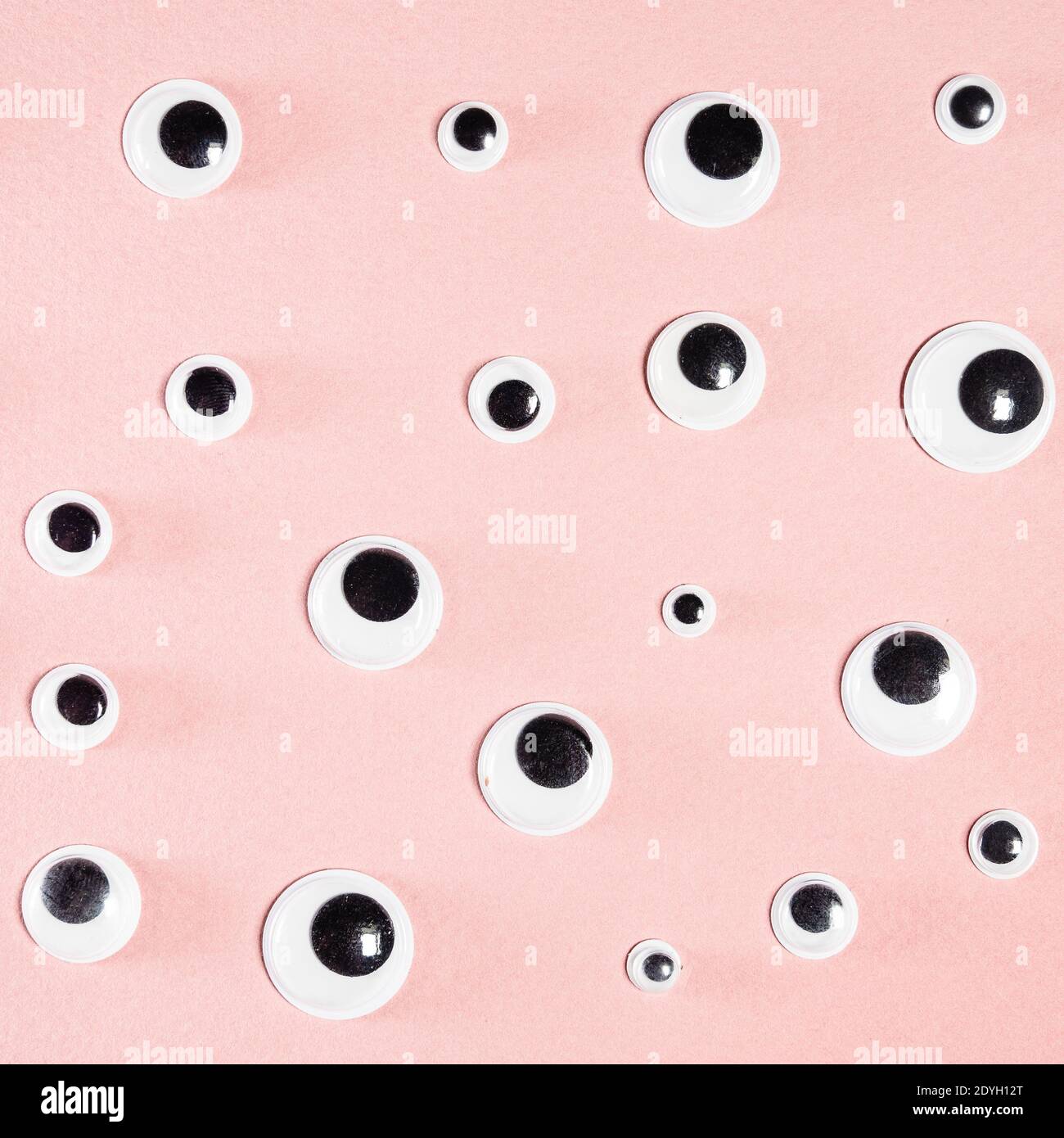 Many Self Adhesive Doll Eyes On Square Pink Paper Background Stock Photo Alamy