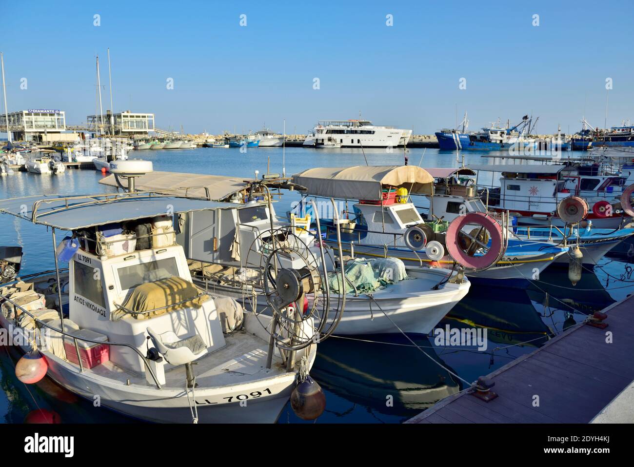 Small inshore commercial fishing boats moored in Limassol old harbour, Cyprus Stock Photo