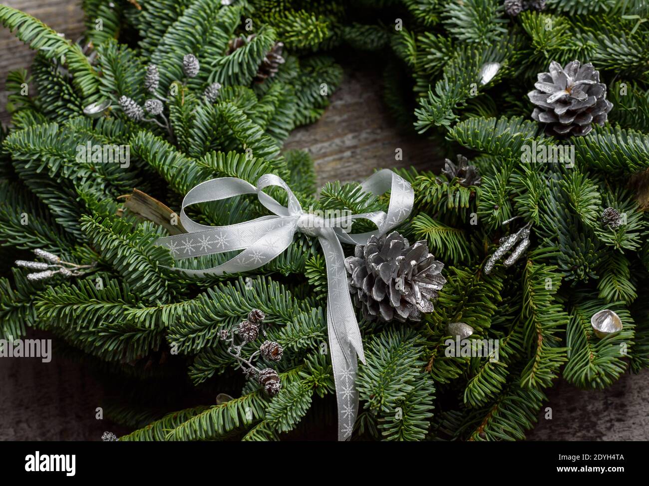 Beauriful green Christmas wreath on a recycled wooden surface, 45 degree angle, rich colors Stock Photo
