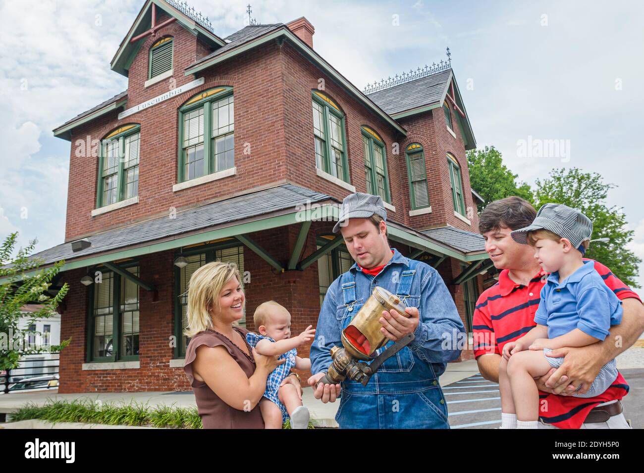 Alabama Tuscumbia Railroad Depot historic train station engineer guide,family parents children mother father son boy,outside exterior, Stock Photo