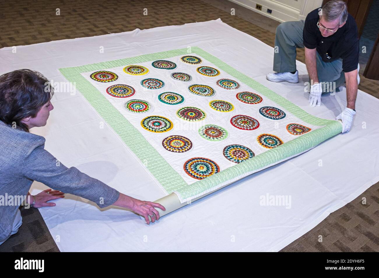 Alabama Montgomery State Department of Archives & History,Pine Burr State Quilt archivists historians unwrapping, Stock Photo