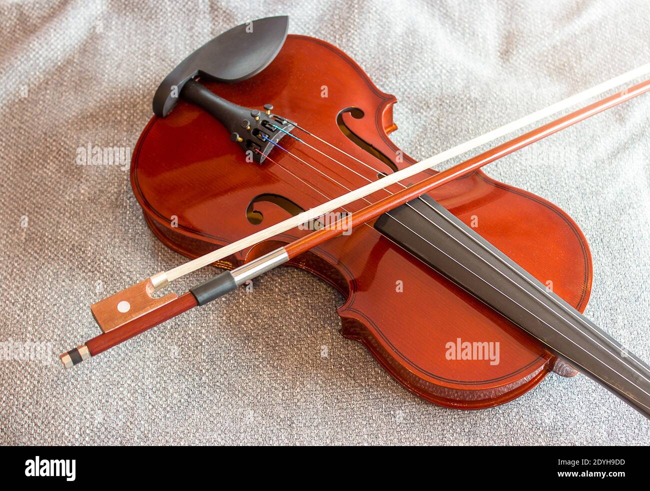 Violin on the bed with fabric background Stock Photo Alamy
