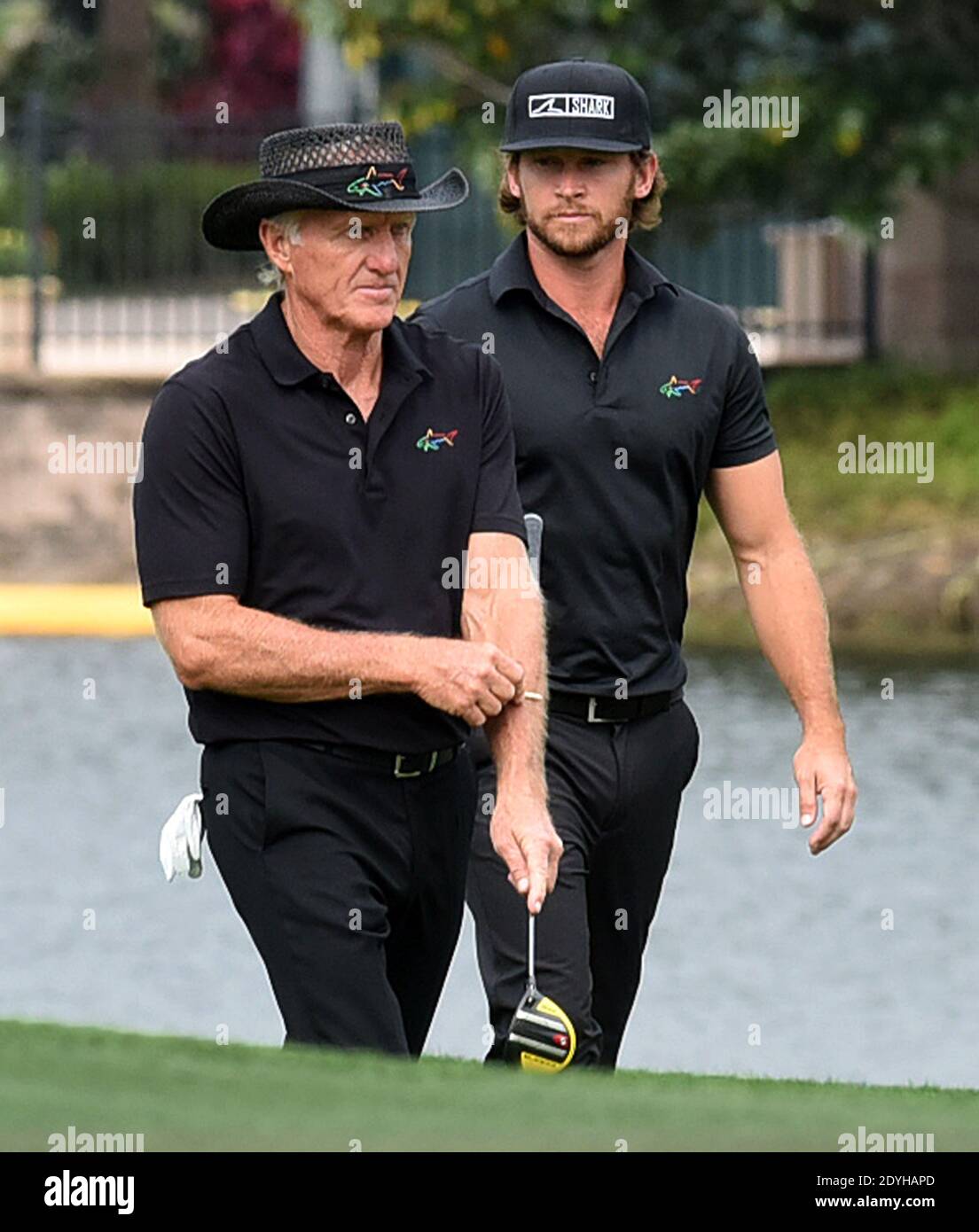 December 20, 2020 - Orlando, Florida, United States - Australian Greg Norman (left) and his son, Greg Norman Jr. approach the 18th green during the final round at the PNC Championship golf tournament at the Ritz-Carlton Golf Club on December 20, 2020 in Orlando, Florida. On Christmas Day, Norman posted a photo to Instagram from a hospital bed where he was being treated for COVID-19 symptoms. NormanÕs son also posted a photo to Instagram, stating that he and his fiancee have tested positive for the COVID-19 virus. (Paul Hennessy/Alamy) Stock Photo