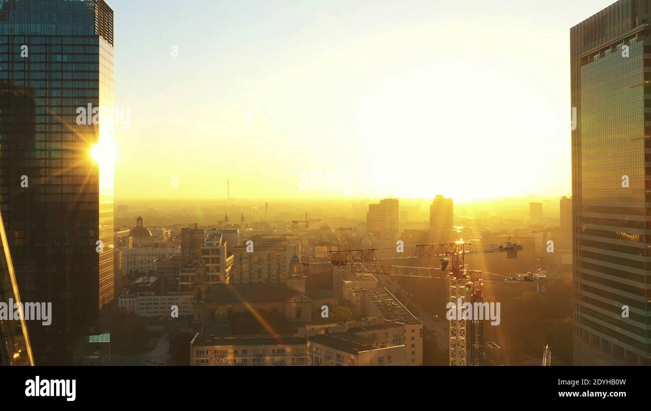 Astonishing sunrise over the Warsaw. Golden sun rising above skyscrapers in the distance drone shot. High quality photo Stock Photo