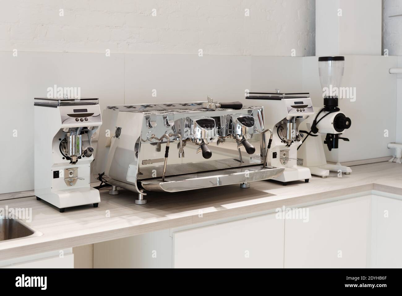 Traditional professional Italian espresso machine and coffee grinders in the new kitchen Stock Photo