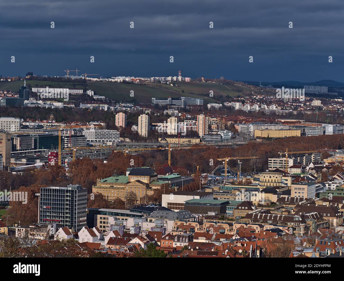 Aerial panorama view of Stuttgart downtown with discolored trees of park area Schlossgarten and construction site of main station development project. Stock Photo