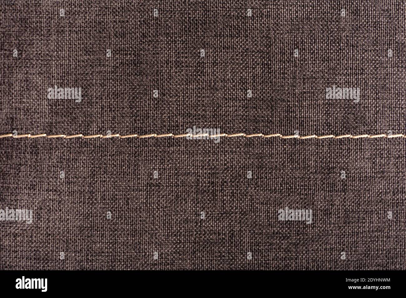Textile surface with stitching. Textured gray background. Stock Photo