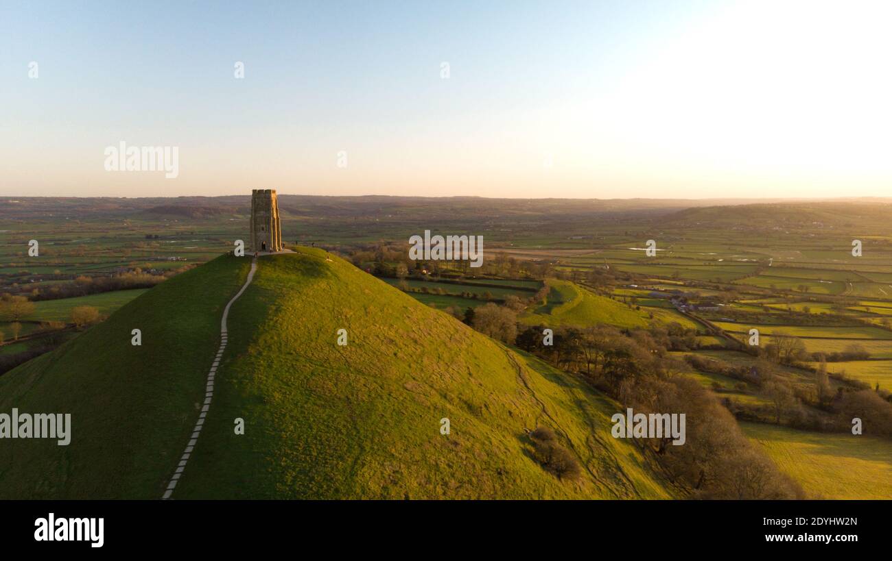Aerial view of the early morning sunrise over Glastonbury Tor with Somerset fields below. Stock Photo