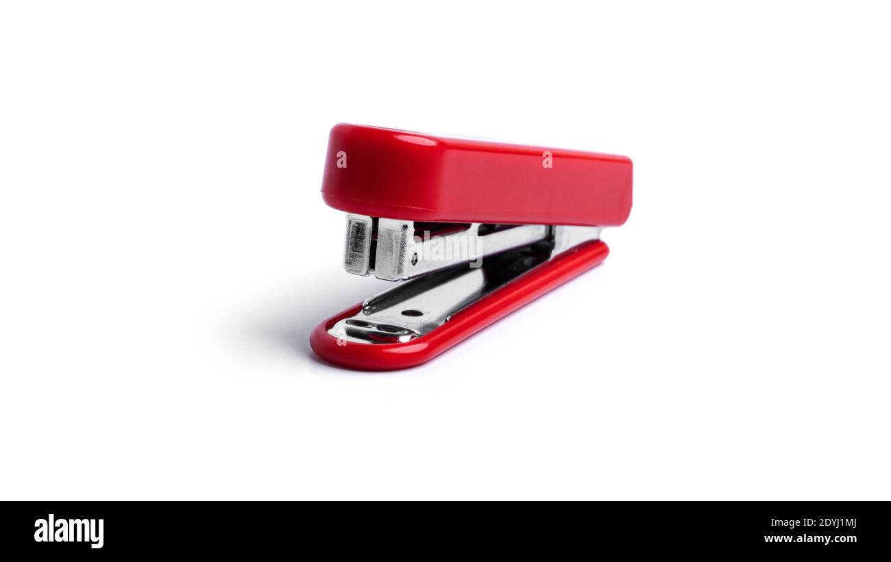 Red stapler on a white background. High quality photo Stock Photo