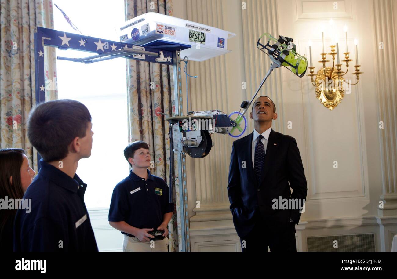 President Barack Obama looks at the Robot 'Vator' created and presented by Victoria Flechter, Rush Lyons, and Thomas Shields from St Vincent de Paul, Theodore Alabama in the State Dining Room of the White House durimg the White House Science Fair. It mimic space space elevators by carrying cargo up a 10 foot pole.The White House Science Fair celebrates the student winners of a broad range of science, technology, engineering and math (STEM) competitions from across the country. The first White House Science Fair was held in late 2010 in Washington, DC, USA, on April 22, 2013. Photo by Aude Guer Stock Photo