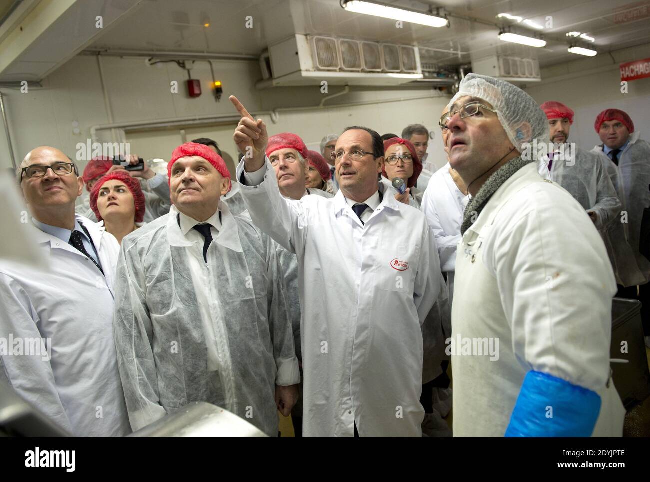 France's President Francois Hollande tours the Jean-Louis Amiotte meat and  sausage factory during a trip to the Doubs departement focused on  employement in rural areas in Avoudrey, France on May 3, 2013.