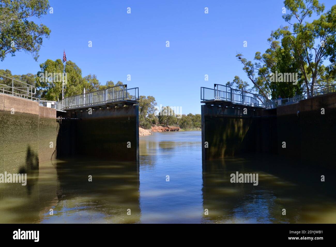 Large mechanical hydraulic gates of Lock 11 on the Murray River in Mildura opening to let boats through to the lower level at the Mildura weir Stock Photo