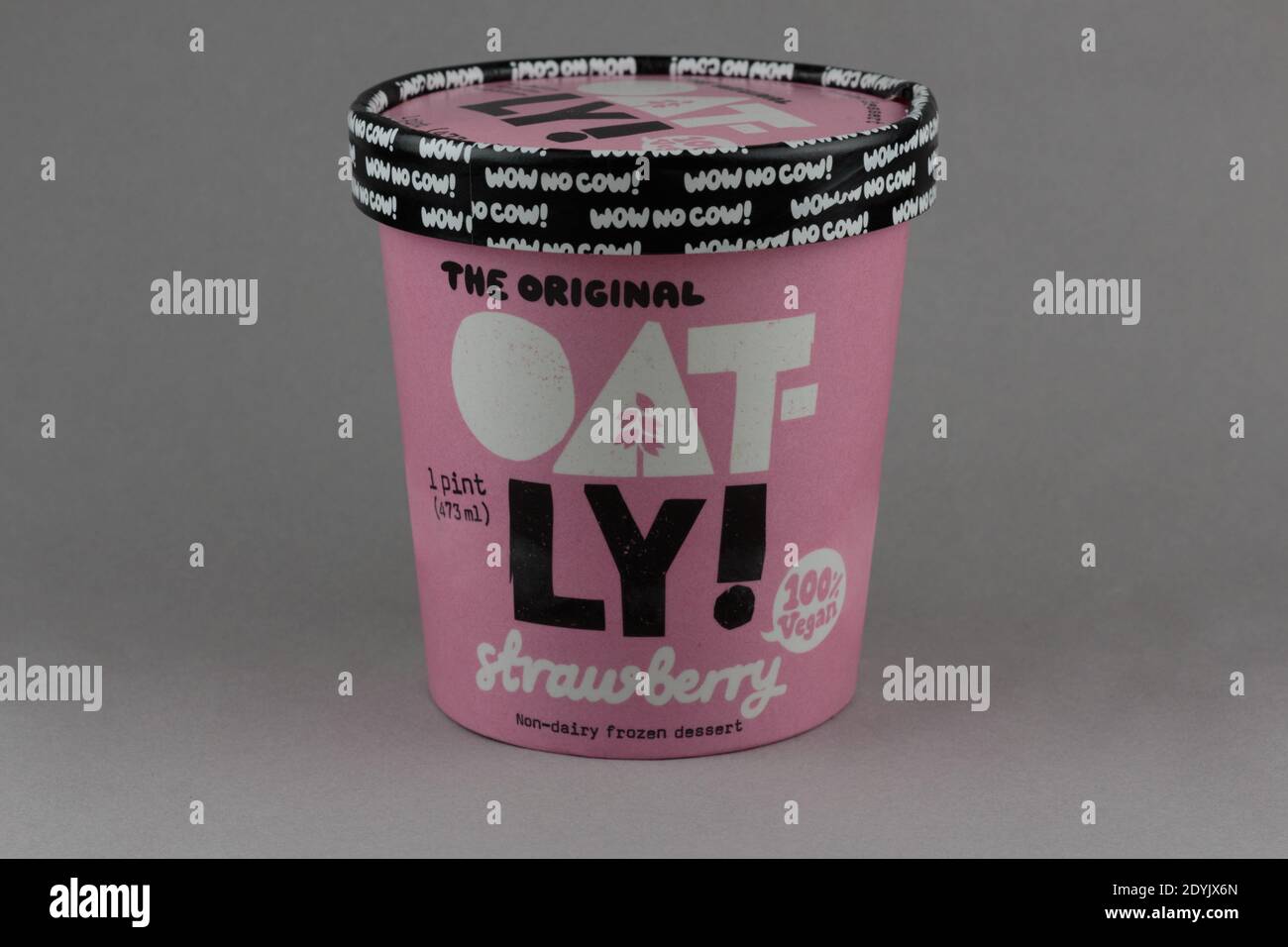 illustrative editorial of a pint of oatly brand strawberry vegan ice cream made with oat milk, a dairy alternative, on a grey background Stock Photo