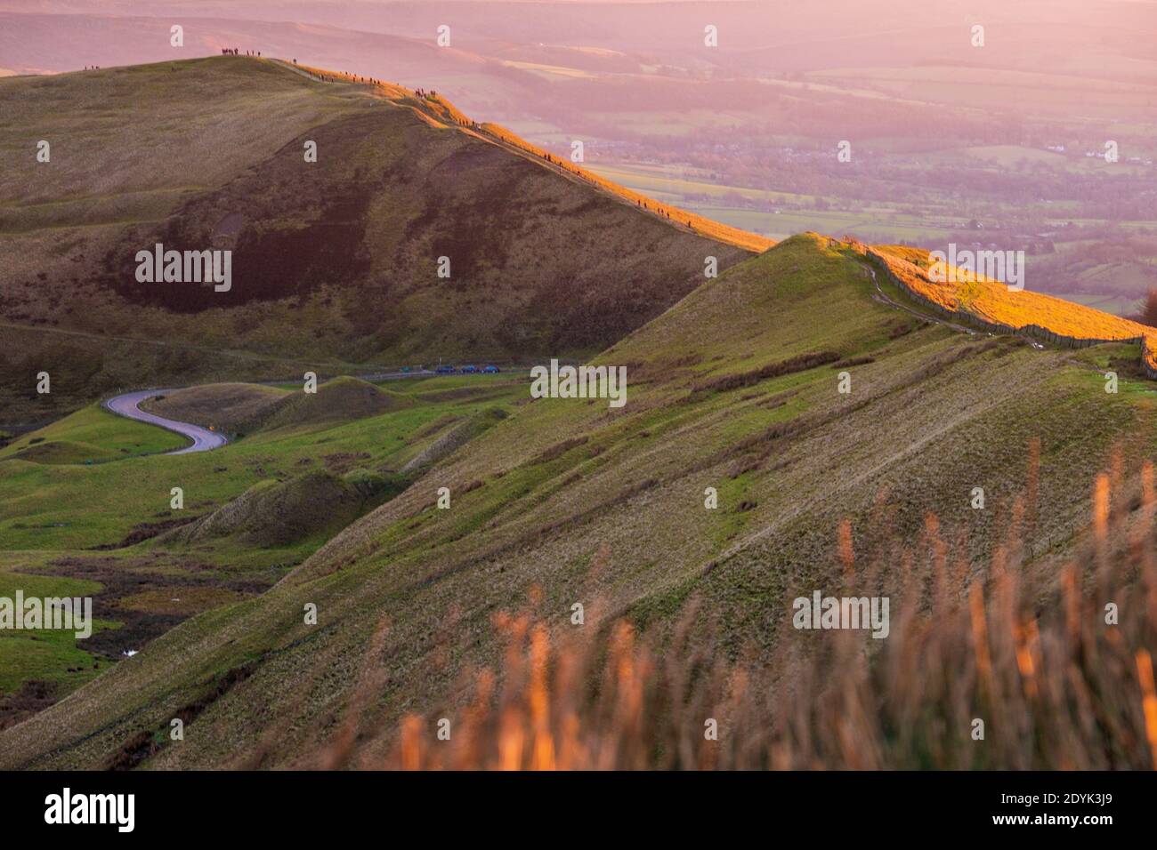 Crowds of people watching the sunrise on Mam Tor, Peak District National Park Stock Photo