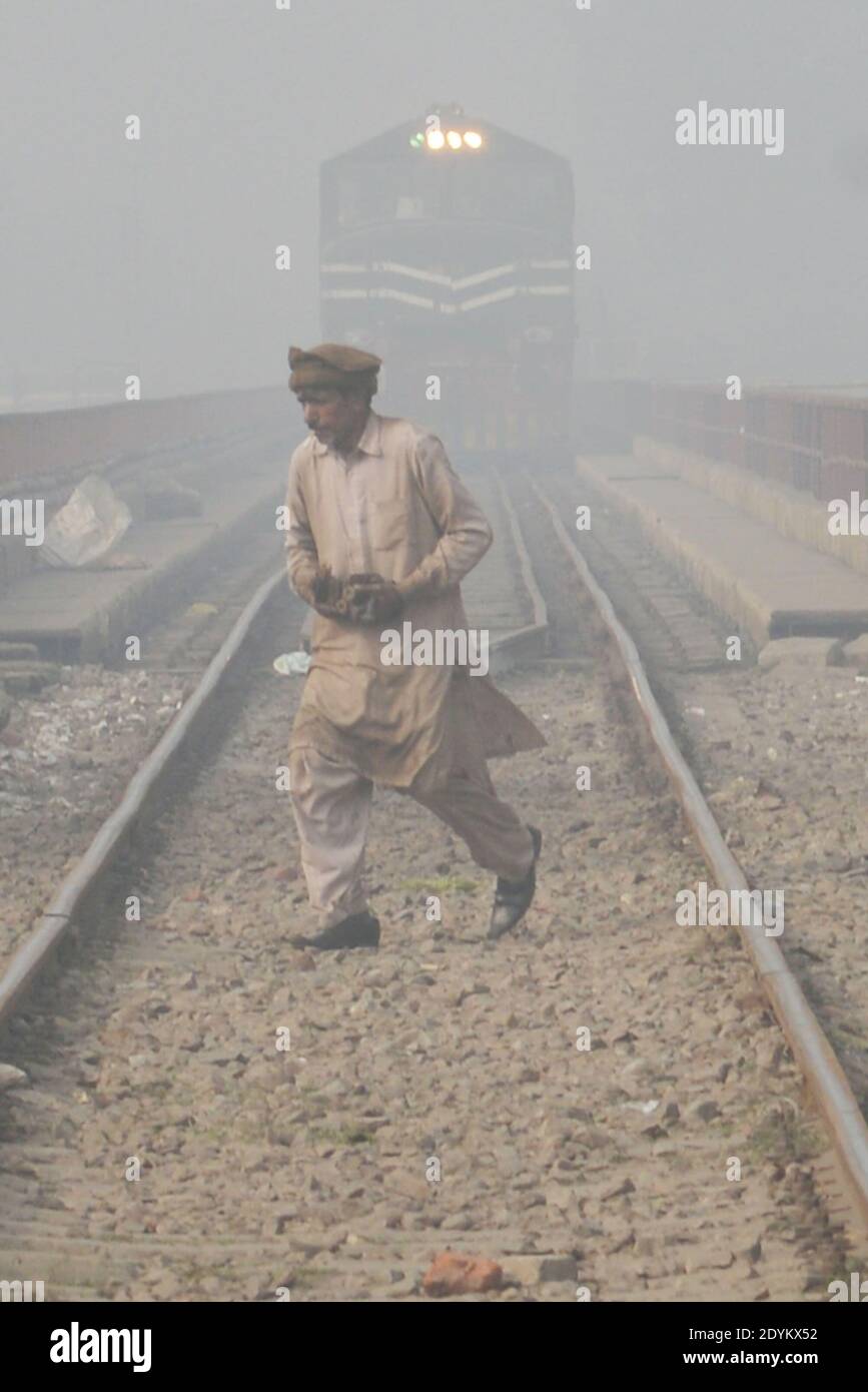 Lahore, Pakistan. 26th Dec, 2020. Commuters make their way amid dense