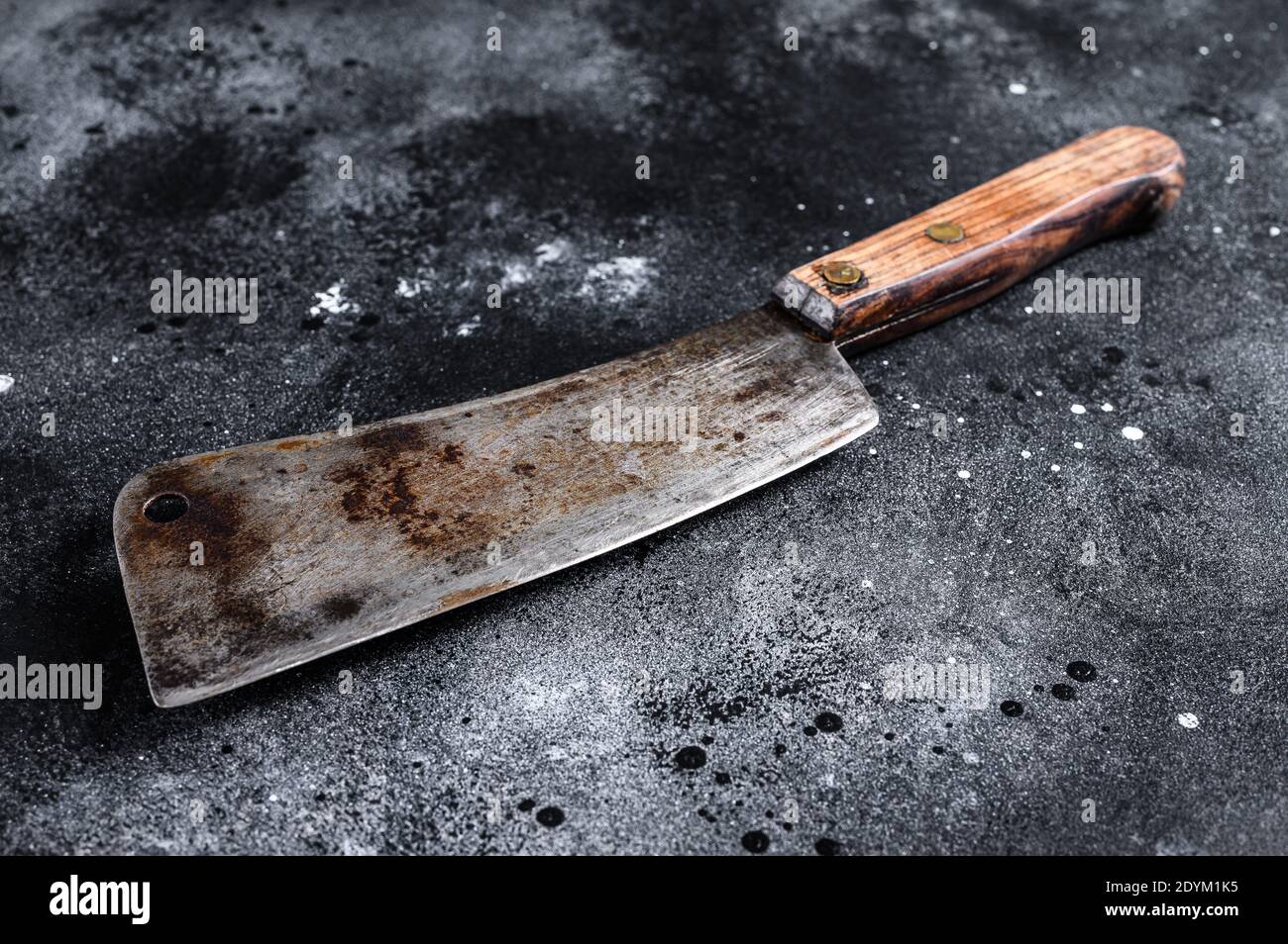 Vintage butcher cleaver with wooden handle. Black background. Top view