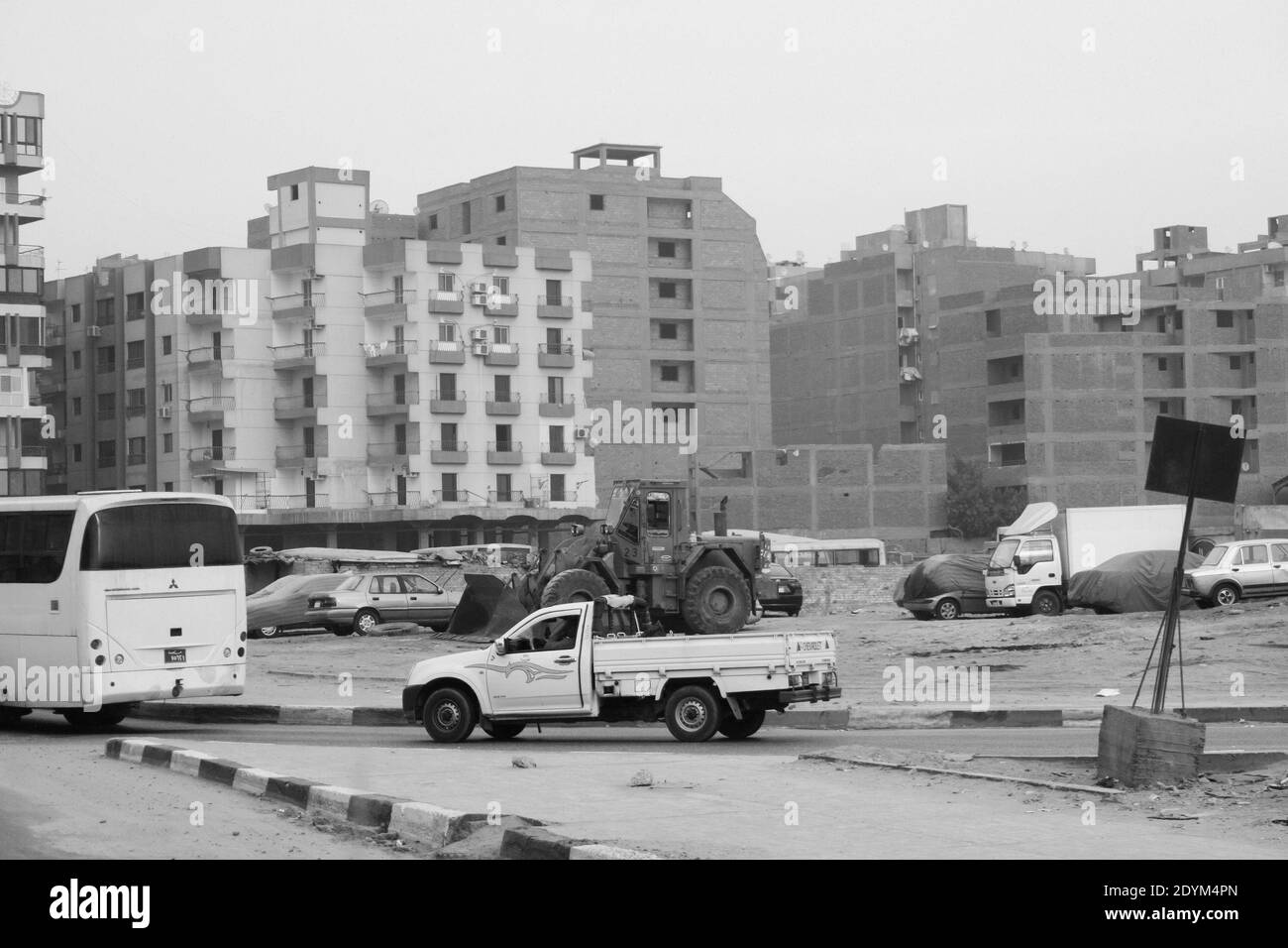 Cairo Egypt : buildings in Cairo with the road with cars, trucks and a bus Stock Photo