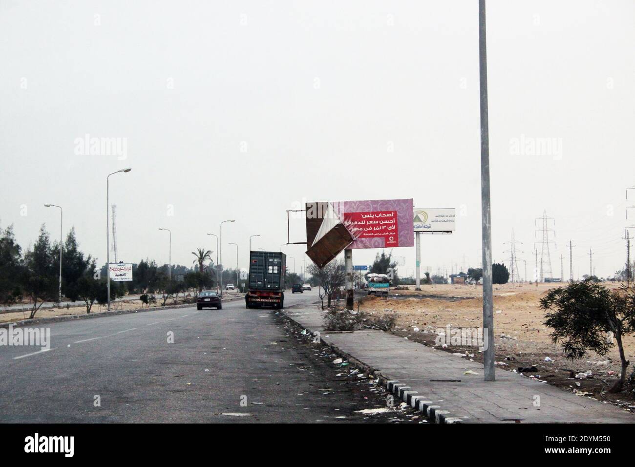 Near Cairo Egypt : the road with a car, a truck and a big ad panel Stock Photo