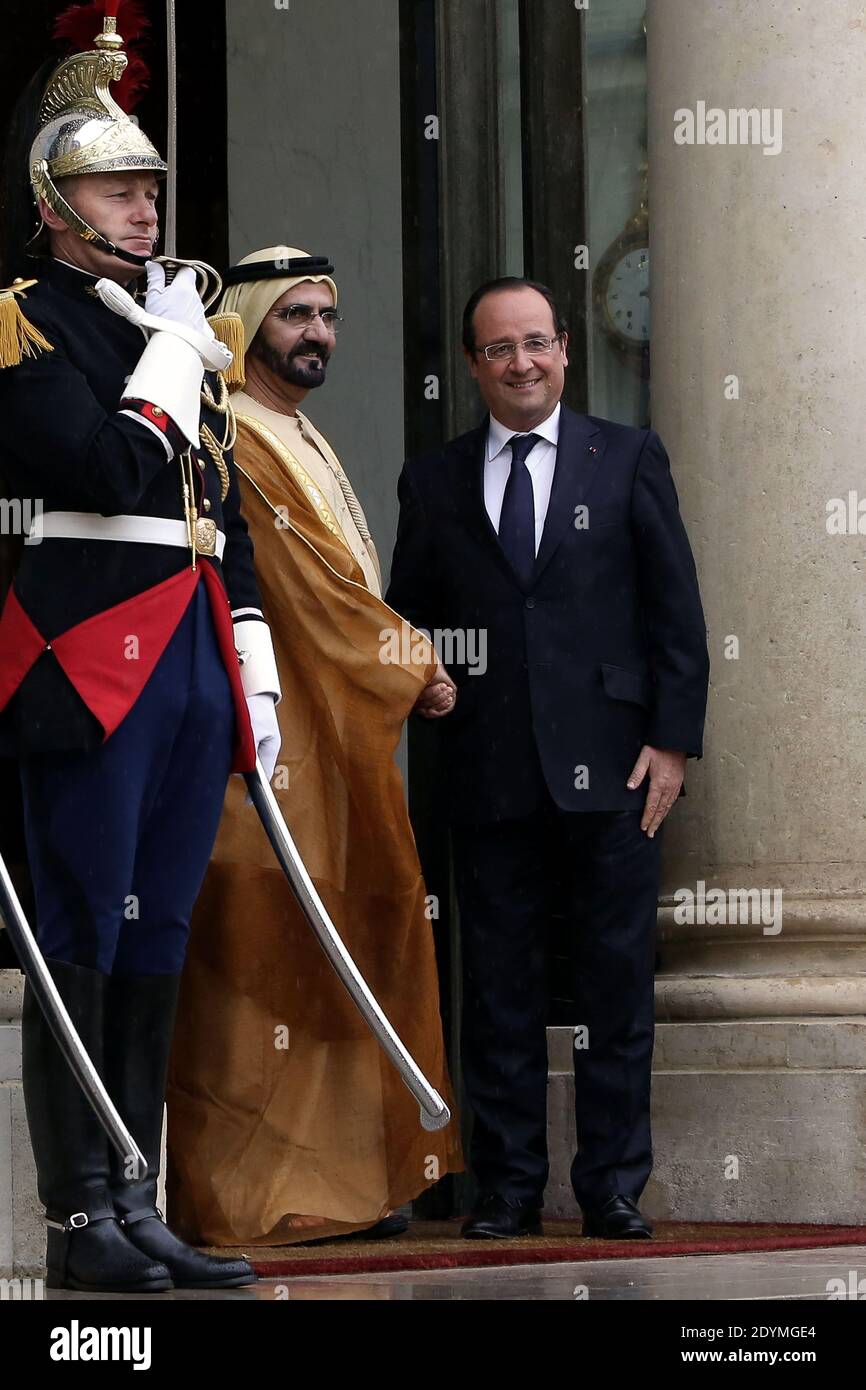 French President Francois Hollande shakes hands with Dubai ruler Sheikh Mohammed bin Rashid al-Maktoum prior to their meeting at the Elysee Palace, in Paris, France on June 13, 2013. Photo by Stephane Lemouton/ABACAPRESS.COM Stock Photo