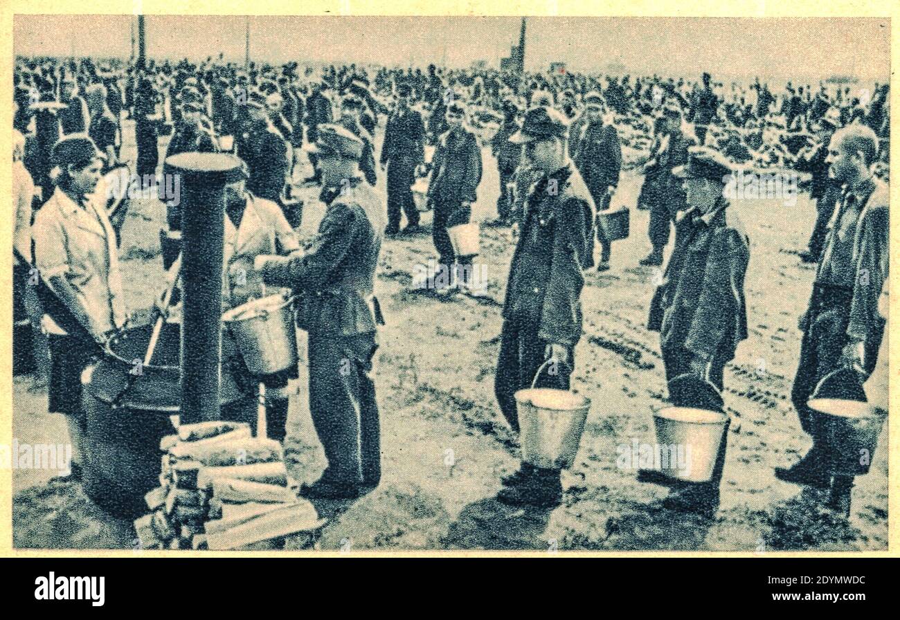 EAST EUROPE - 1944: German soldiers in POW camp. In the photo German soldiers are queuing for food, portion of soup. Archive black and white photo. Stock Photo