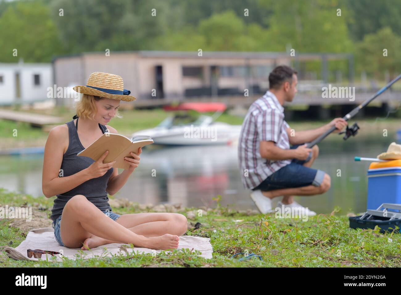 People Rading Fish couple relaxing in nature fishing and reading Stock Photo - Alamy