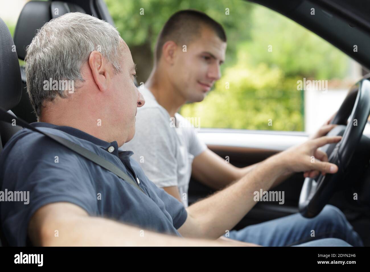 young man having driving lesson Stock Photo