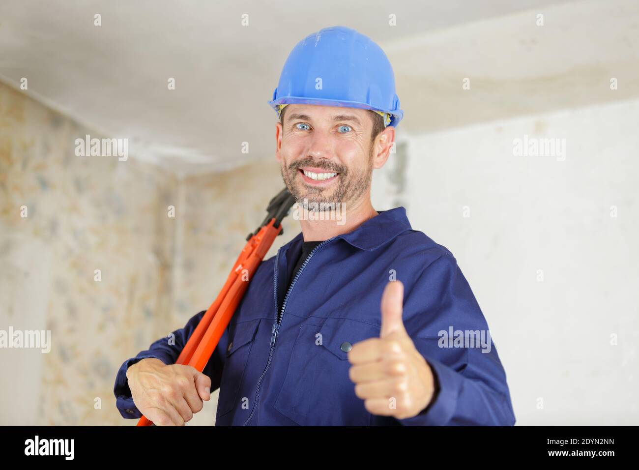 a worker uses scissors indoors Stock Photo