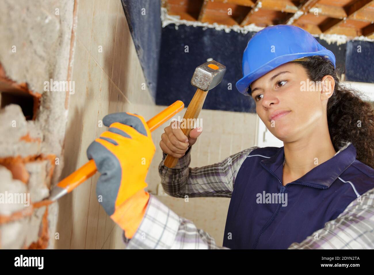 woman hammers a nail into the wall Stock Photo - Alamy