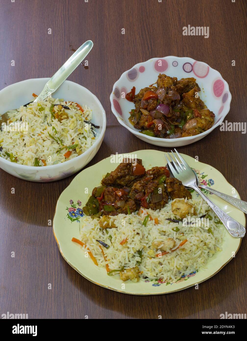 chinese food served on plate. delicious and tempting fried rice and chilli chicken. famous in indian restaurants. close up shot. top view. Stock Photo