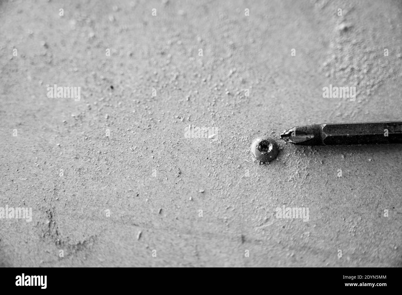 Damaged screw head caused by using the wrong bit and speed to install Stock Photo